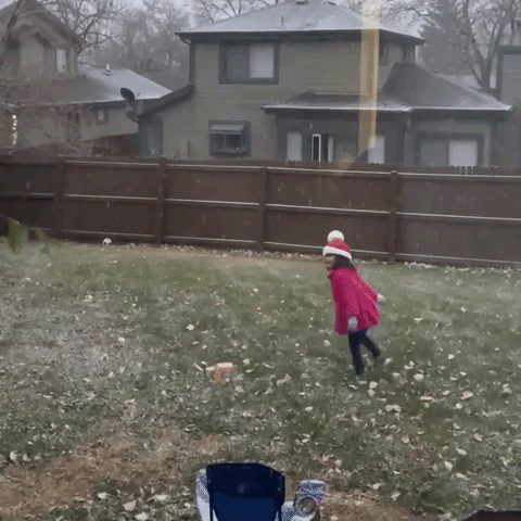 Overjoyed Child Frolics as Snow Falls in Denver