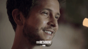 the resident smile GIF