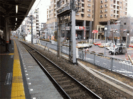 Photo gif. An empty train stop suddenly has three pieces of sushi approach the terminal. A shrimp jumps on top of an empty rice bed and the sushi train takes off again.