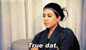 Reality TV gif. Kourtney Kardashian sits with her arms crossed. She has a slightly serious look on her face and nods as she says, “True dat.” 
