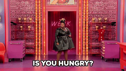 Reality TV gif. Kornbread Jeté from RuPaul's Drag Race is standing in the middle of the runway and she juts out a hip while asking, "Is you hungry!?"