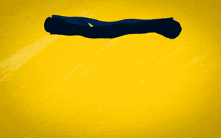 Text gif. The text, "Go Blue M," is written on a blue banner that unrolls and waves in the wind and the background is yellow.