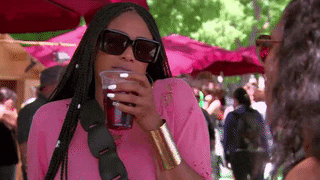Reality TV gif. Tami Roman on Basketball Wives distorts her face in disgust, then pretends to gag.