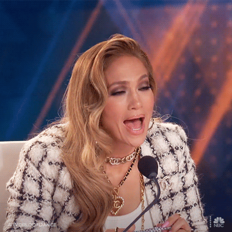 TV gif. In a clip from World of Dance, Jennifer Lopez leans forward to speak into her microphone, and seems to be saying "wow!"