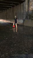 Woman Helps to Clear Clogged Drains During Flash Flooding in Queens