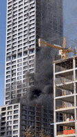Workmen Seen Atop Burning Skyscraper in Istanbul