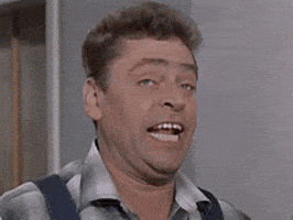 Video gif. Man with expressive blue eyes makes a derpy face before exaggerating his shocked reaction to something. His eyebrows raise higher, his eyes keep widening, and his jaw drops lower and lower.