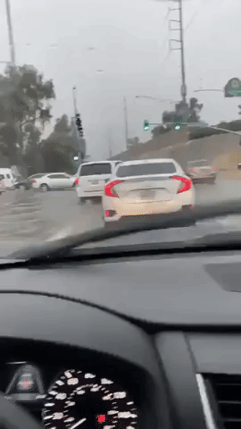 Cars Drive Through Floodwater After 'Very Heavy Rain' in Phoenix
