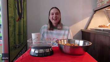 Competitive Eater Attempts World Record for Most Chicken Nuggets Eaten in One Minute
