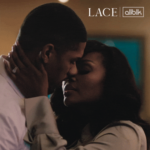 TV gif. Maryam Basir as Lacey and Norman Towns as Gideon on Lace. They share an intimate kiss and Lacey holds Gideon's face in her hands. 