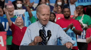 Politics gif. Joe Biden at a rally, with a crowd of people cheering behind him, smiling while speaking into a podium mic saying, "Oh yeah. Oh yeah," which appears as text.