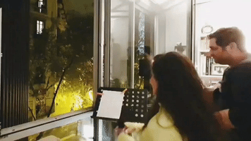 Syrian Couple in Barcelona Perform Songs at Their Window to Entertain Neighbors