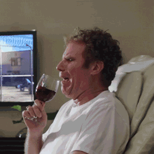Celebrity gif. Will Ferrell bounces in a vibrating chair as he tries to sip from a wine glass that spills down his front.