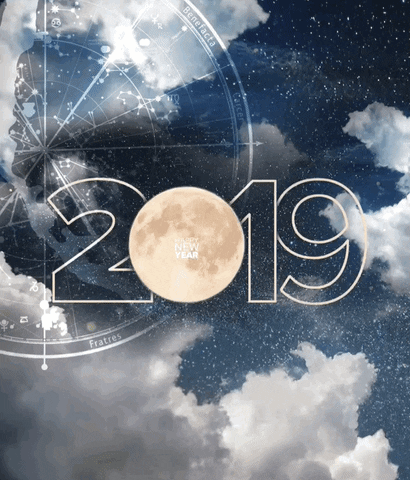 Digital art gif. Astrological chart rests against a photo of a cloudy night sky as gold snowflakes fall softly around the message, “Happy New Year 2019.”