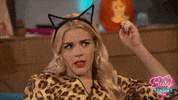Reality TV gif. Busy Philipps on Busy Tonight,  wearing cat ears and shaking her head with judgement and throwing an open palm, speechless.