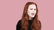 Celebrity gif. Madelaine Petsch winks at us emphatically with her head turned to the side.