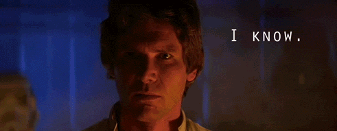 Movie gif. Harrison Ford as Han Solo in Star Wars stands with half of his face in shadow as he gazes fiercely and says, "I know."