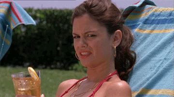 TV gif. Rachel Bilson as Summer in The OC. She's lounging on a pool chair and her brow is furrowed as she checks someone out, liking what she's seeing.