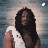 Ad gif. Dressed in a white toga, Lil B raises his hands together in prayer, and a Twitter-blue halo descends onto his head.