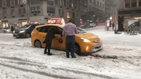 New York City Taxi Gets Stuck in Snow on 6th Avenue