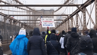 Anti-Vaccine-Mandate Protesters March Over Brooklyn Bridge, Rip Up Cards