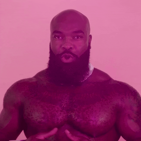 Video gif. A shirtless bald man with a full beard wearing a bow tie sings, “good night.”