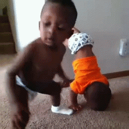 Video gif. Two baby toddlers, stripped down to their diapers, one grooving to a hip-hop beat, one walking up the wall into a headstand, both bump and twerk with the enthusiasm of a very drunk adult.