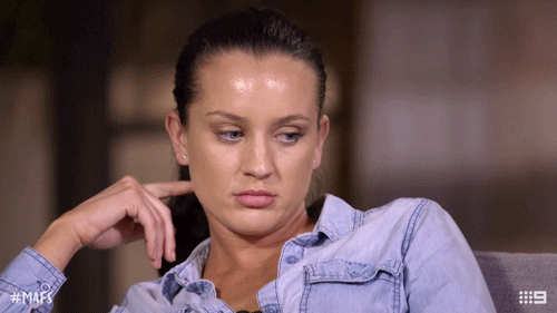 Reality TV gif. A woman from Married at First Sight widens her eyes in silent rage as she listens to her fellow cast members during a reunion interview.