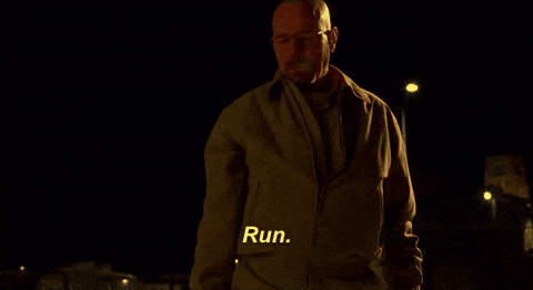 TV gif. Zoom in on Bryan Cranston as Walter White on Breaking Bad as he stands in the dark of a cold night. He looks intimidatingly up at someone as condensation breathes out of his mouth like smoke as he says, “Run.”