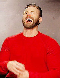 Celebrity gif. Chris Evans throws his head back in hysterical laughter.