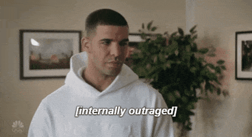 Celebrity gif. Looking annoyed, Drake quietly seethes. Text, “Internally outraged.”