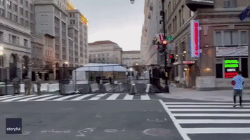 Duo Toss Football in Empty Street Amid Tightened Security Measures in Washington