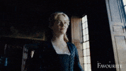 Movie gif. Emma Stone as Abigail in The Favourite walks through a hall, cringing.