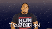 Video gif. Man wearing a RUN DMC shirt stands in animated rain as he shrugs and says, “I’m strugglin’. That’s all I got.”