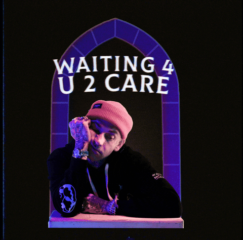 Video gif. A man in a beanie rests a cheek on his fist then lifts his head and looks at his watch. Text, "Waiting for you to care."