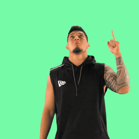 Celebrity gif. NFL player Bradlee Anae looks above him with a grateful nod as he points to the sky.