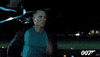 Movie gif. Daniel Craig as James Bond in Casino Royale is drenched in sweat as he runs at full speed down an airplane runway at night. An airplane lands behind him.