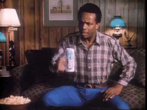 TV gif. In a retro scene from Soul Train, a perplexed man reaches out to grab a floating Colt 45 beer, and then he begins to float away, led by the beer.