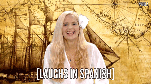 A woman is laughing and the words - [LAUGHS IN SPANISH] are written below.