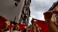Crowd in Pamplona Flashes Red in Preparation for Bull Run
