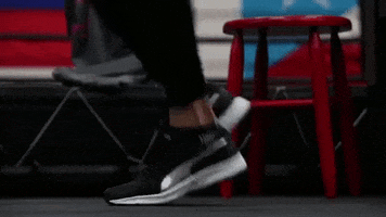 Video gif. Shot of a woman's shoes running in place. She hops shuffles back and forth in the middle of her exercise.