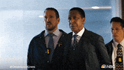 TV gif. Danielle Moné Truitt as Ayanna on Law and Order. A man she has arrested is being taken away by FBI officers and he glares at her as he passes by. She doesn't make eye contact and stands her ground.
