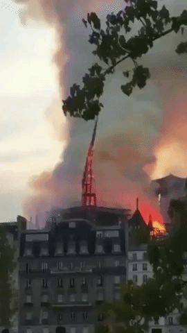 Spire Falls as Fire Rages at Notre Dame in Paris