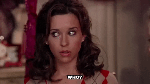 Movie gif. Lacey Chabert as Gretchen Wieners in Mean Girls looks around with big confused eyes while she says, “Who?”