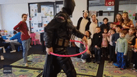 Hula-Hooping Batman Draws Laughter From Ukrainian Refugees in Poland