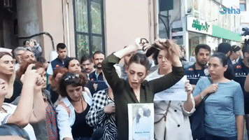 Woman Cuts Hair in Protest Outside Iranian Consulate in Istanbul