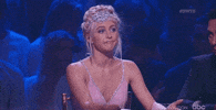 Reality TV gif. Julianne Hough sits as a judge on Dancing With The Stars and nods slowly, pursing her lips in agreement.
