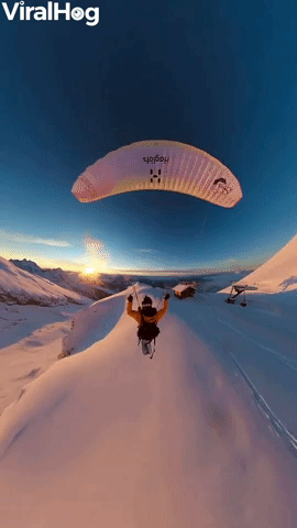 Paraglider Flies Over Golden Hour Mountains
