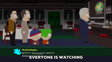 South Park gif. Kyle walks towards us as Stan and three men in suits turn our way in the background. He shrugs and says, "Everyone is watching."