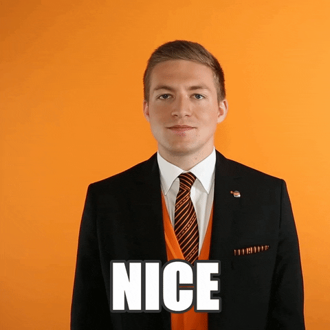 Video gif. Man in a suit smiles and winks at us, giving us a thumbs-up. Text, “Nice.”